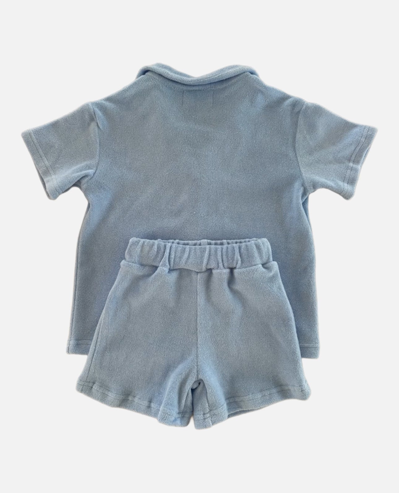 Flat lay of sky terry set, button up t-shirt and matching shorts, reverse view